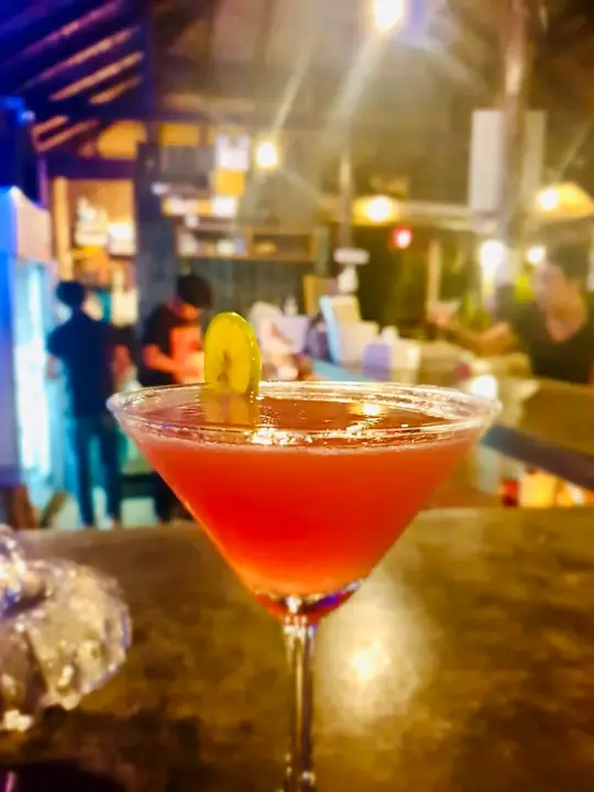 Red cocktail on a table in the evening