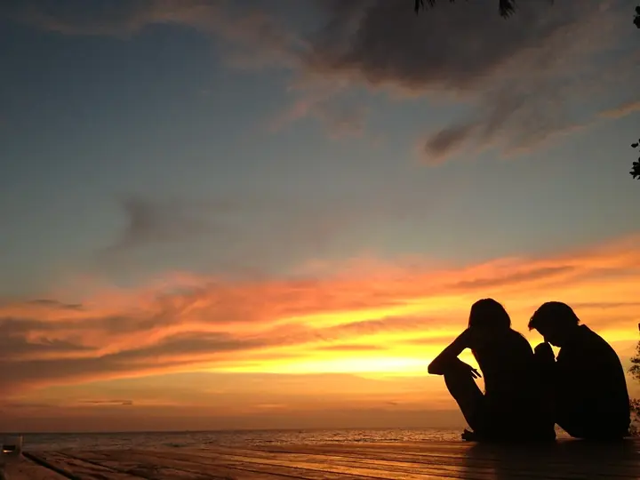 Two guests watching the sunset from the deck